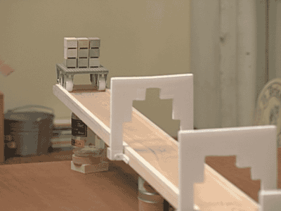 a cart rolling down a slope with a number of stacked cubes, it passes through a number of gates, each gate removing some of the cubes from the cart, it ends up with a single cube.