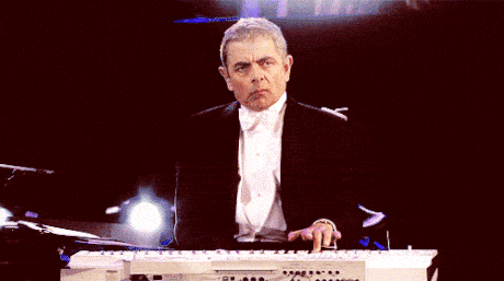 Mr Bean is repeatedly pressing a keyboard button and looks bored